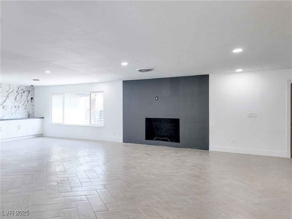4501 South Woodcrest Road Las Vegas, NV 89121 - Photo 8 of 78 Unfurnished living room with recessed lighting and a large fireplace