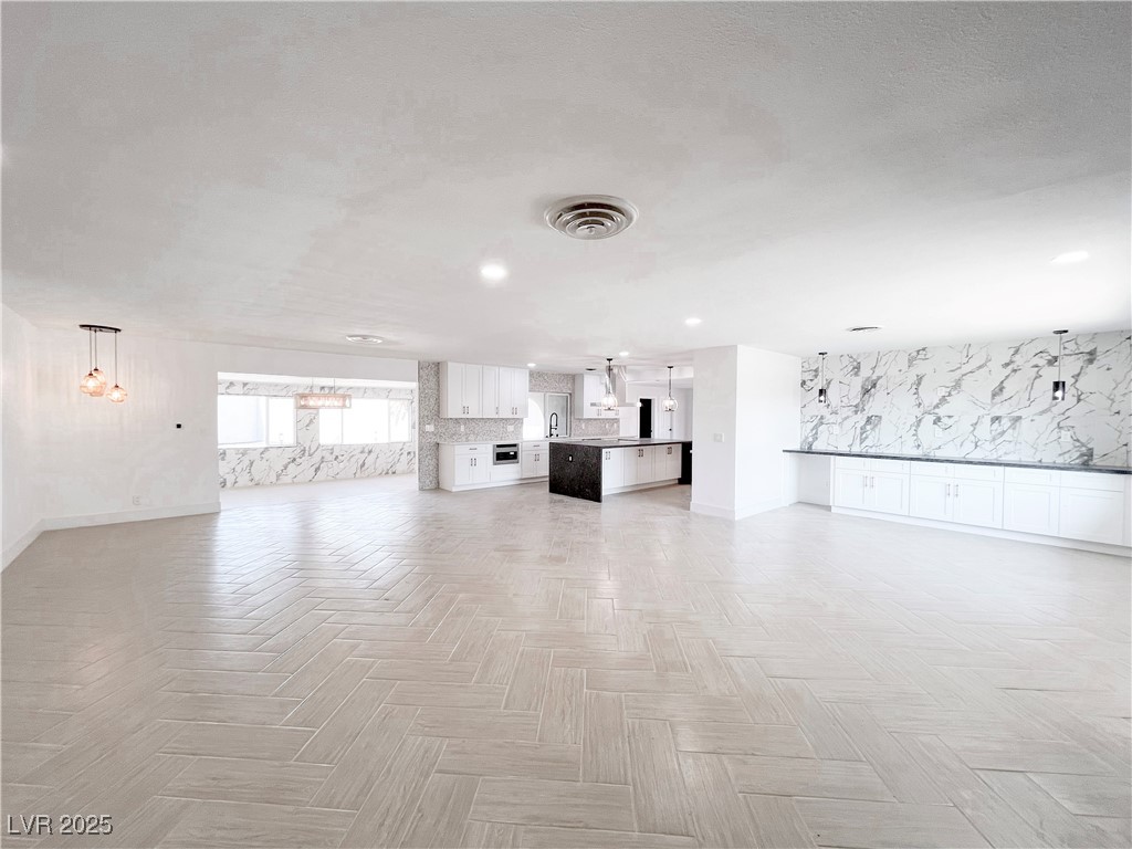 4501 South Woodcrest Road Las Vegas, NV 89121 - Photo 9 of 78 Unfurnished living room featuring baseboards