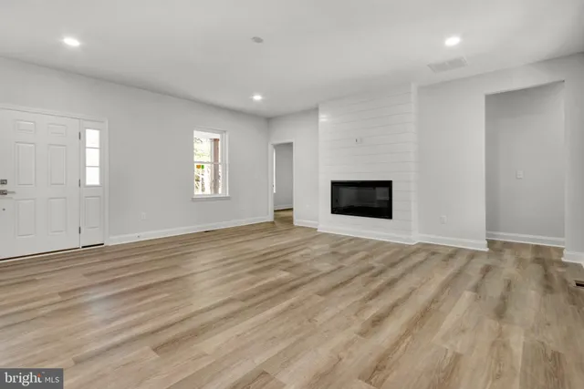 an empty room with window and fireplace