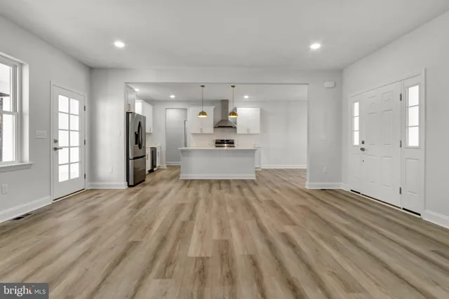 a view of a kitchen with a sink and a refrigerator