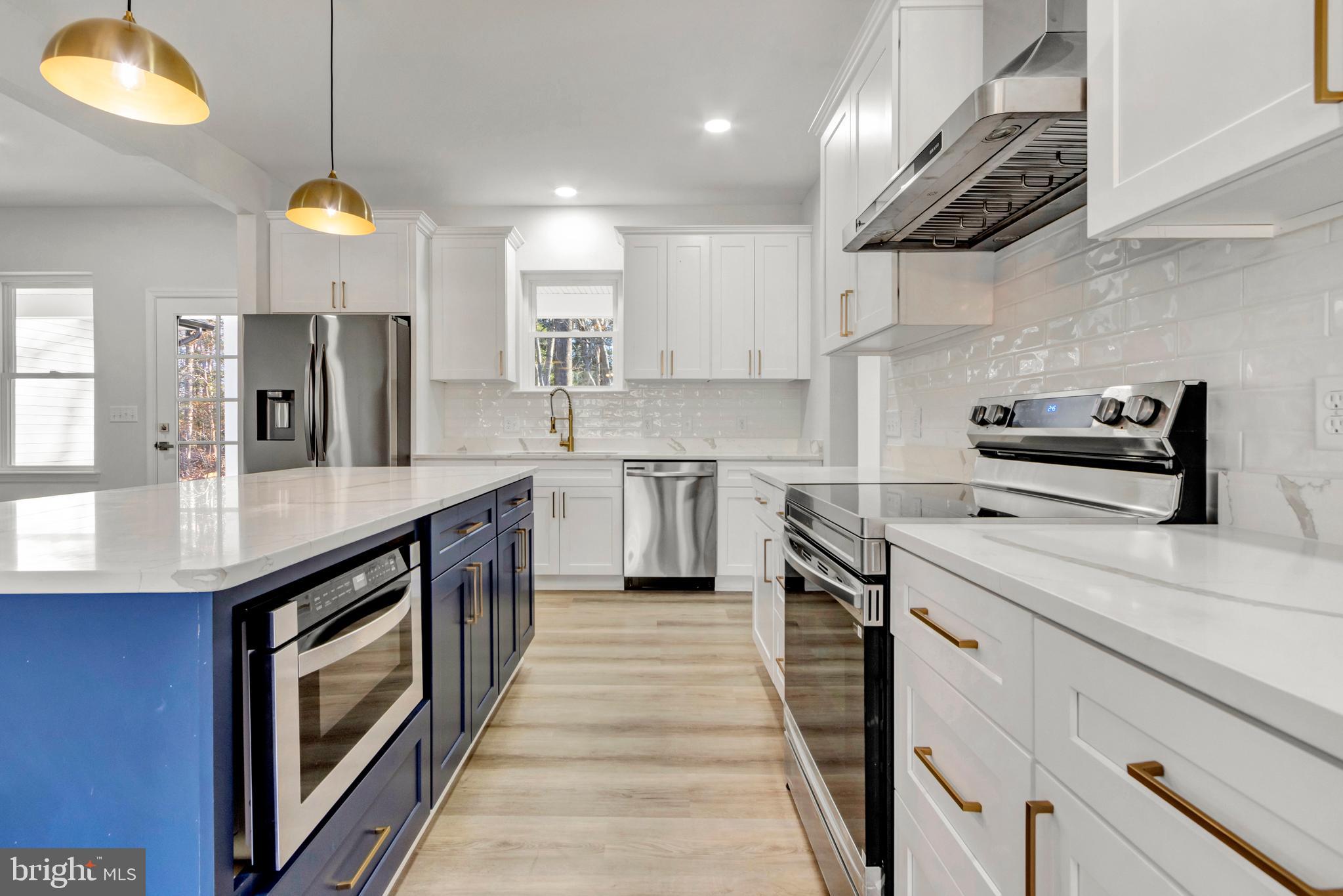 22527 Lawson Road Georgetown, DE 19947 - Photo 18 of 53 a kitchen with stainless steel appliances granite countertop a sink a stove and a refrigerator