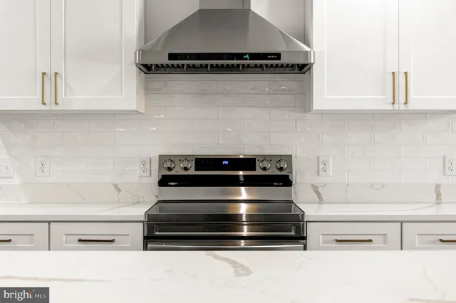 a kitchen with stainless steel appliances a stove a sink dishwasher and cabinets with wooden floor