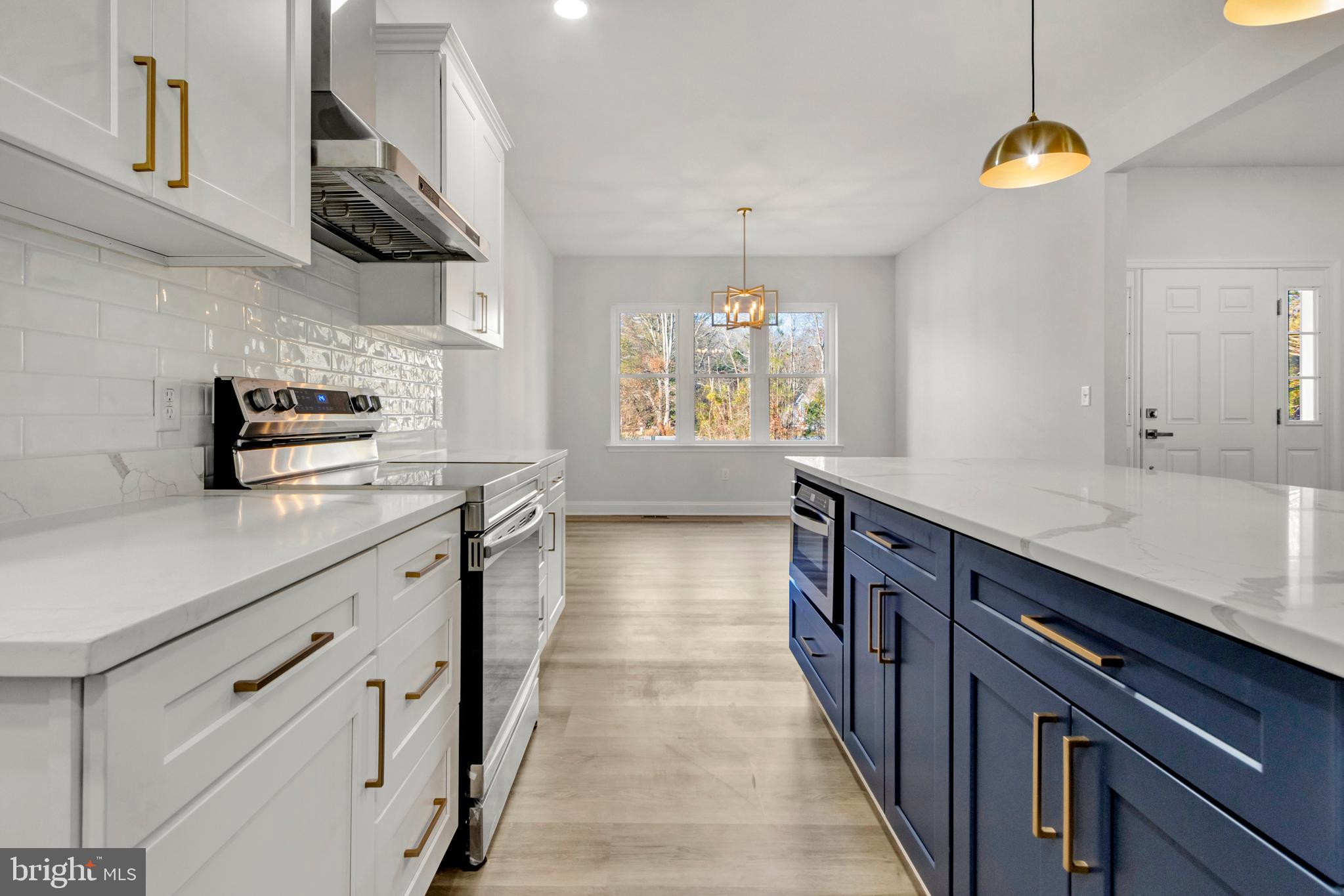 22527 Lawson Road Georgetown, DE 19947 - Photo 20 of 53 a kitchen with stainless steel appliances a stove a sink dishwasher and cabinets with wooden floor