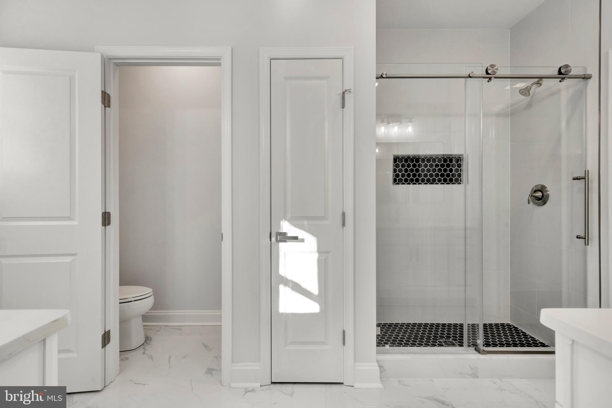 22527 Lawson Road Georgetown, DE 19947 - Photo 28 of 53 a bathroom with a glass shower door