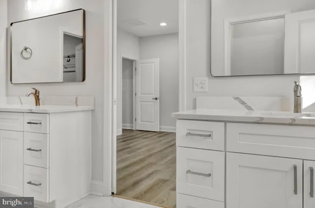a bathroom with a double vanity sink mirror and double