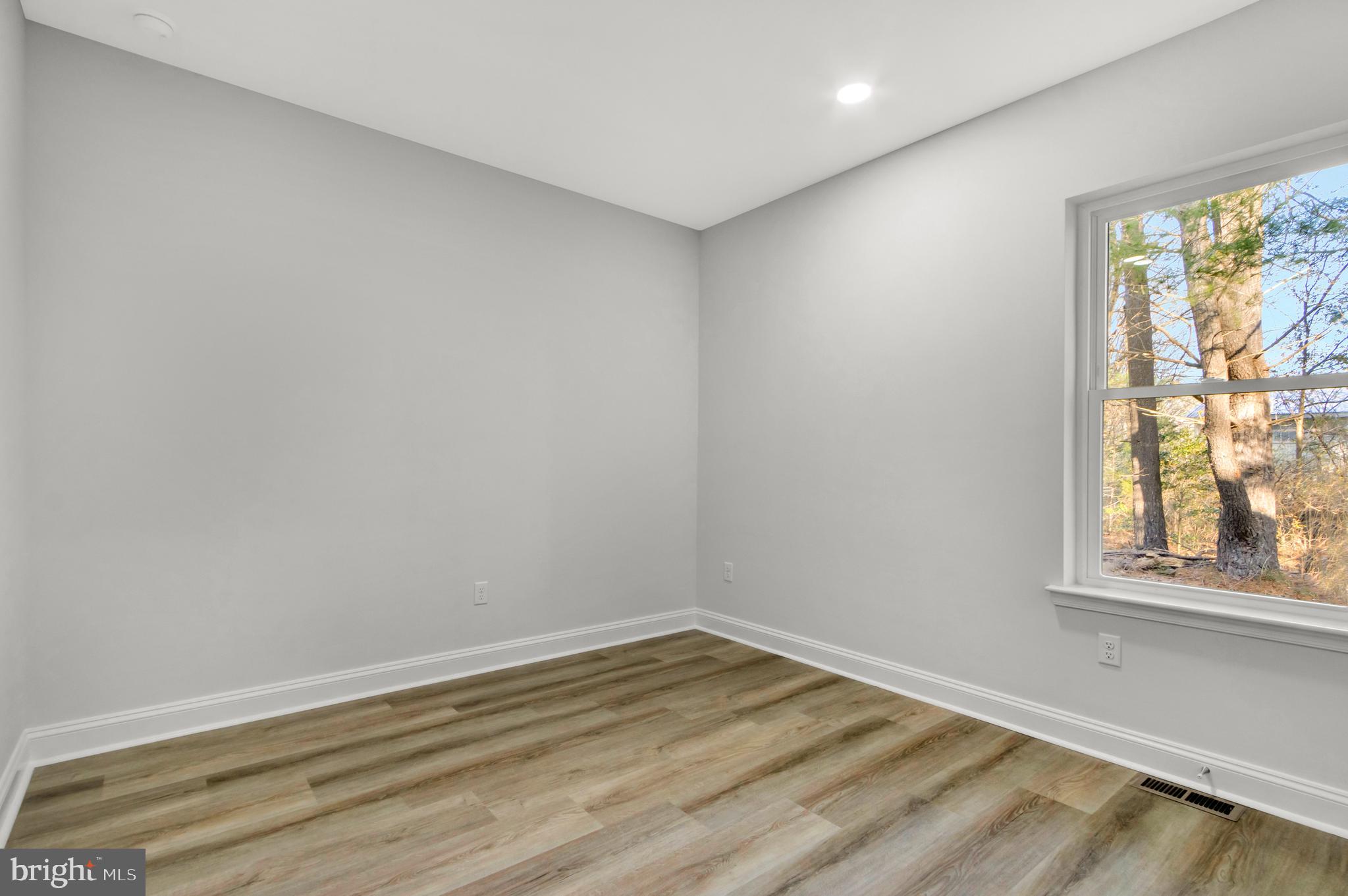 22527 Lawson Road Georgetown, DE 19947 - Photo 37 of 53 a view of empty room with wooden floor and fan