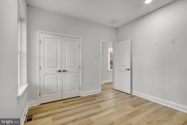 a bathroom with a granite countertop toilet sink and mirror