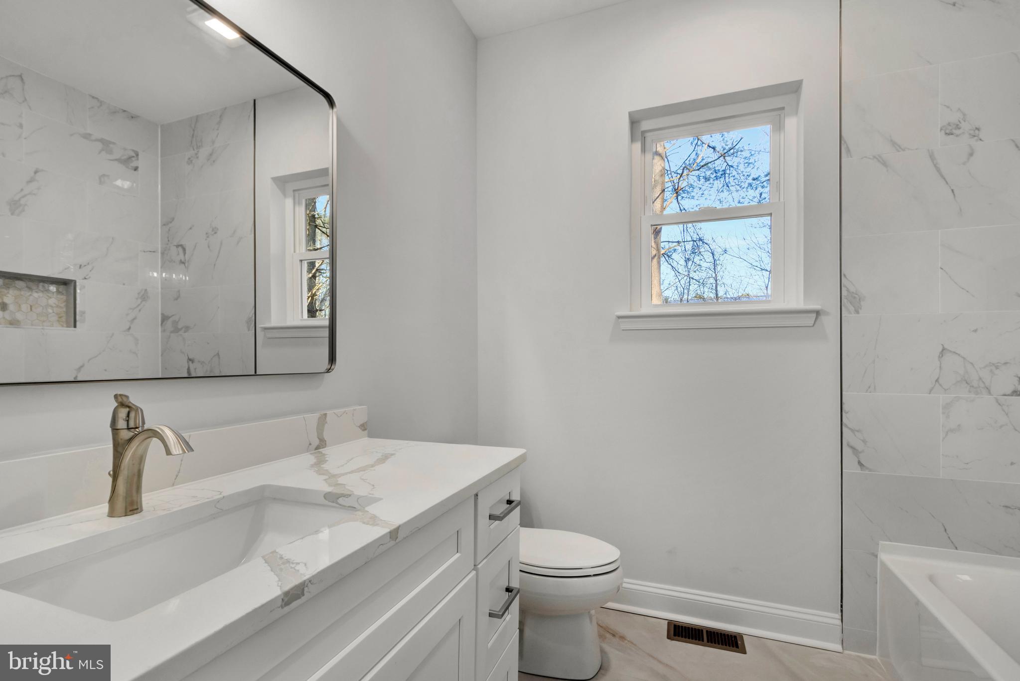 22527 Lawson Road Georgetown, DE 19947 - Photo 39 of 53 a bathroom with a granite countertop toilet sink and mirror
