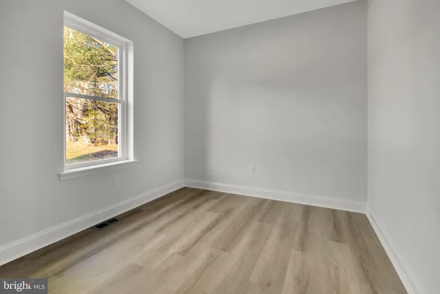 wooden floor in a hall with an empty room
