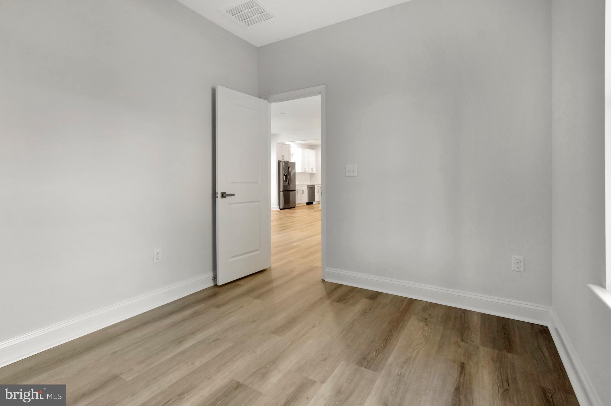 22527 Lawson Road Georgetown, DE 19947 - Photo 45 of 53 wooden floor in a hall with an empty room