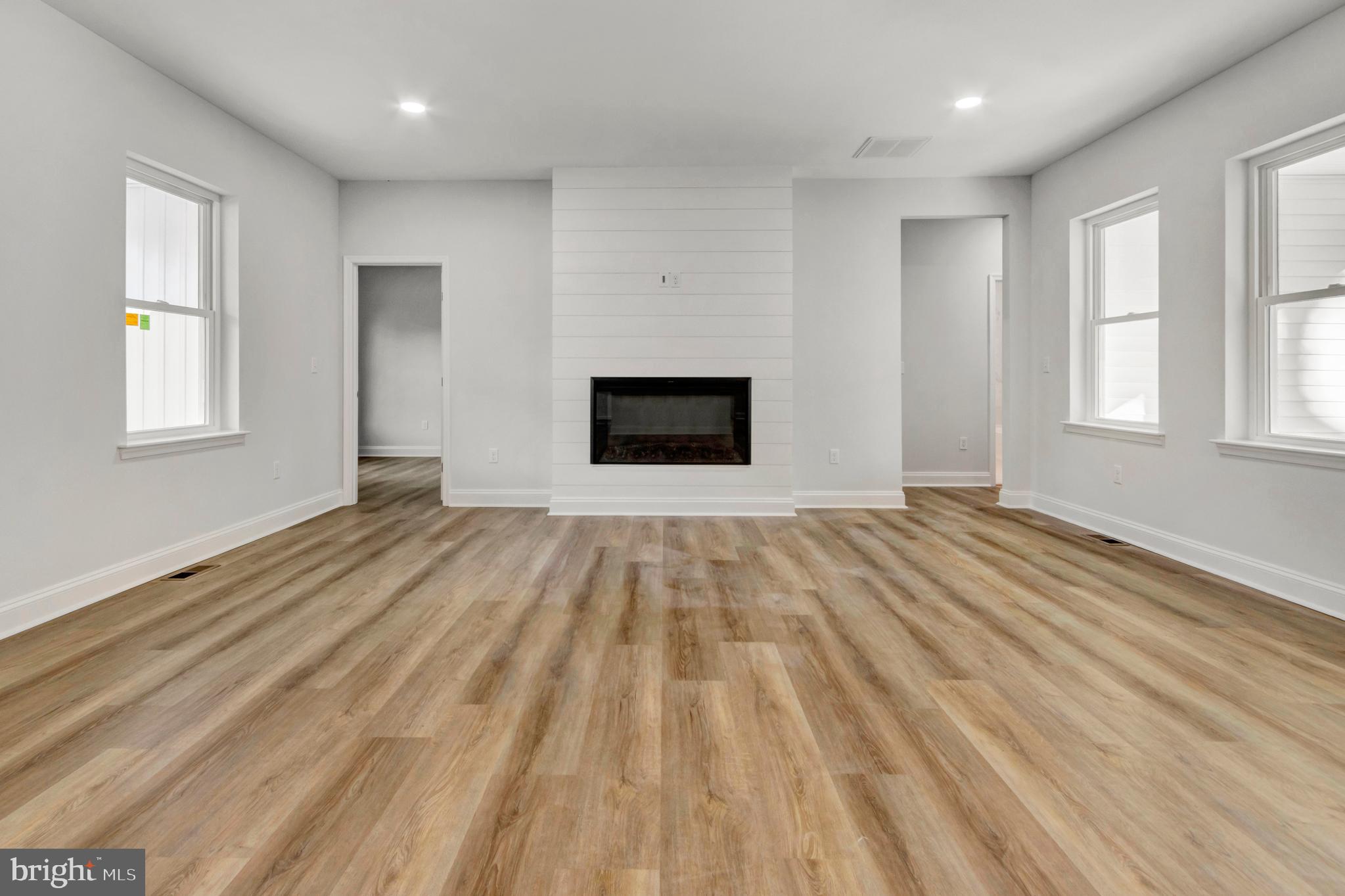 22527 Lawson Road Georgetown, DE 19947 - Photo 9 of 53 an empty room with wooden floor and windows