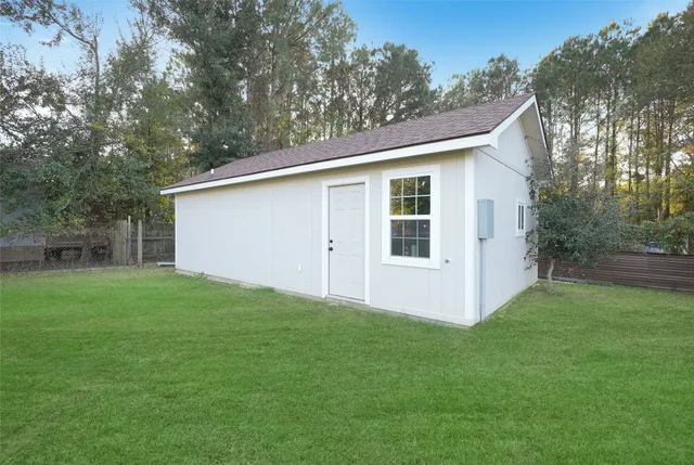 a view of backyard of house with green space