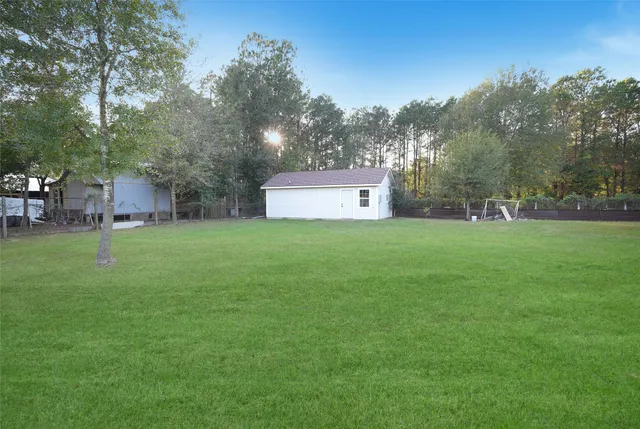a backyard of a house with table and chairs