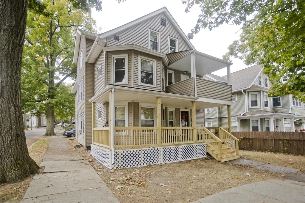 107 Orange Street Springfield, MA 01108 - Photo 1 of 38 a front view of a house with a garden