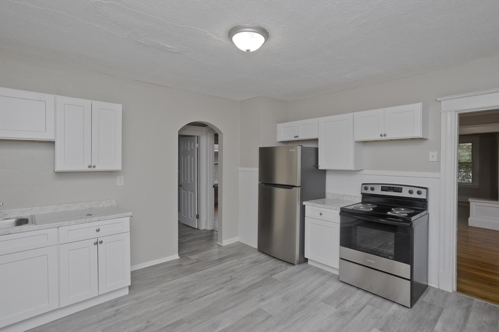 107 Orange Street Springfield, MA 01108 - Photo 12 of 38 a kitchen with stainless steel appliances a refrigerator stove and sink