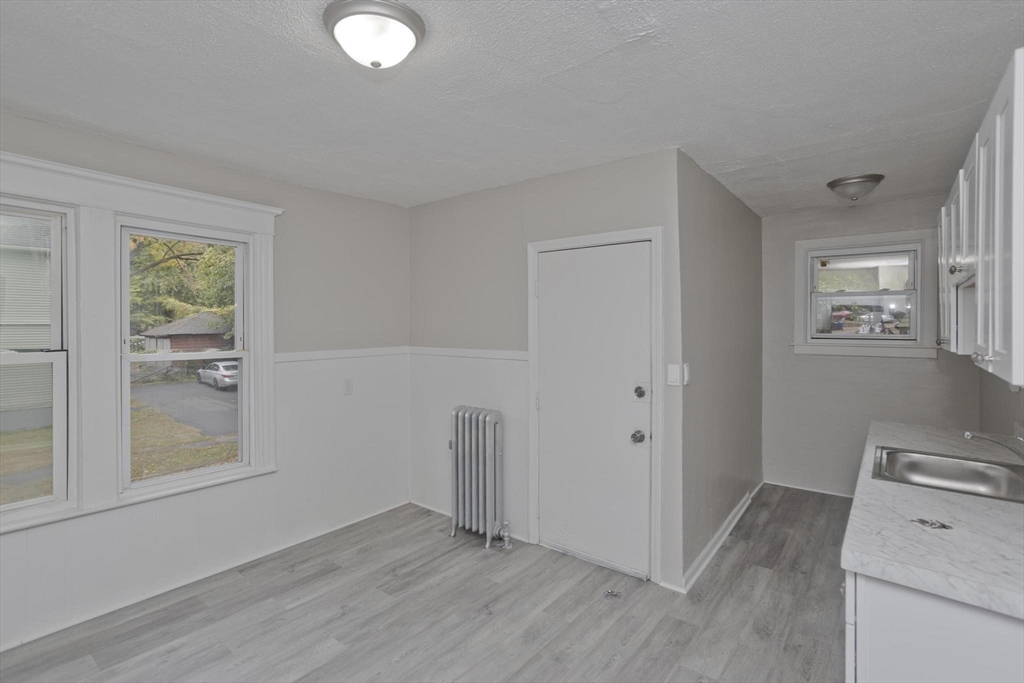 107 Orange Street Springfield, MA 01108 - Photo 13 of 38 an empty room with windows and closet