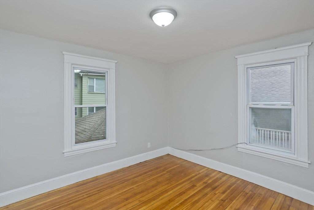 107 Orange Street Springfield, MA 01108 - Photo 14 of 38 an empty room with wooden floor and windows