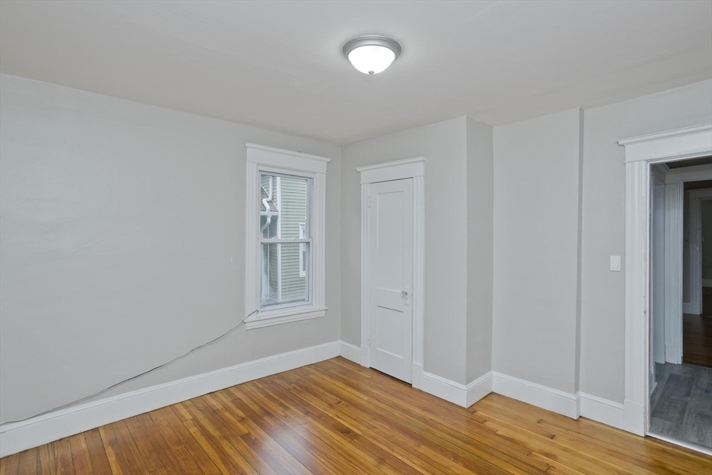 107 Orange Street Springfield, MA 01108 - Photo 15 of 38 a view of empty room with wooden floor and fan