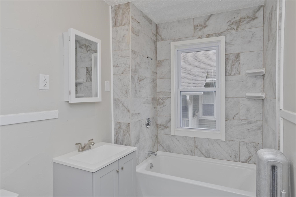 107 Orange Street Springfield, MA 01108 - Photo 18 of 38 a bathroom with a sink mirror toilet and bathtub