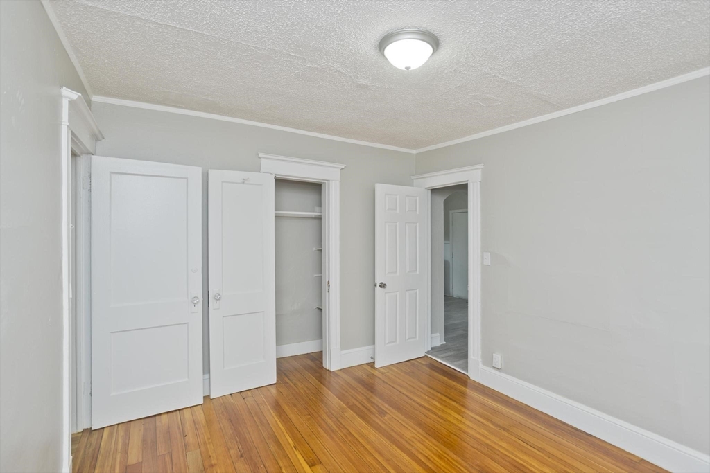 107 Orange Street Springfield, MA 01108 - Photo 20 of 38 a view of empty room with wooden floor and fan