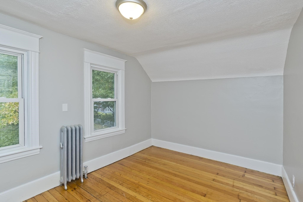 107 Orange Street Springfield, MA 01108 - Photo 22 of 38 a view of empty room with wooden floor and fan