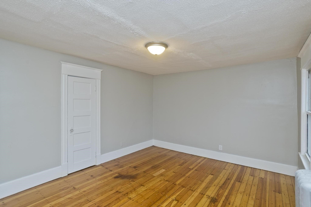 107 Orange Street Springfield, MA 01108 - Photo 26 of 38 a view of empty room with wooden floor
