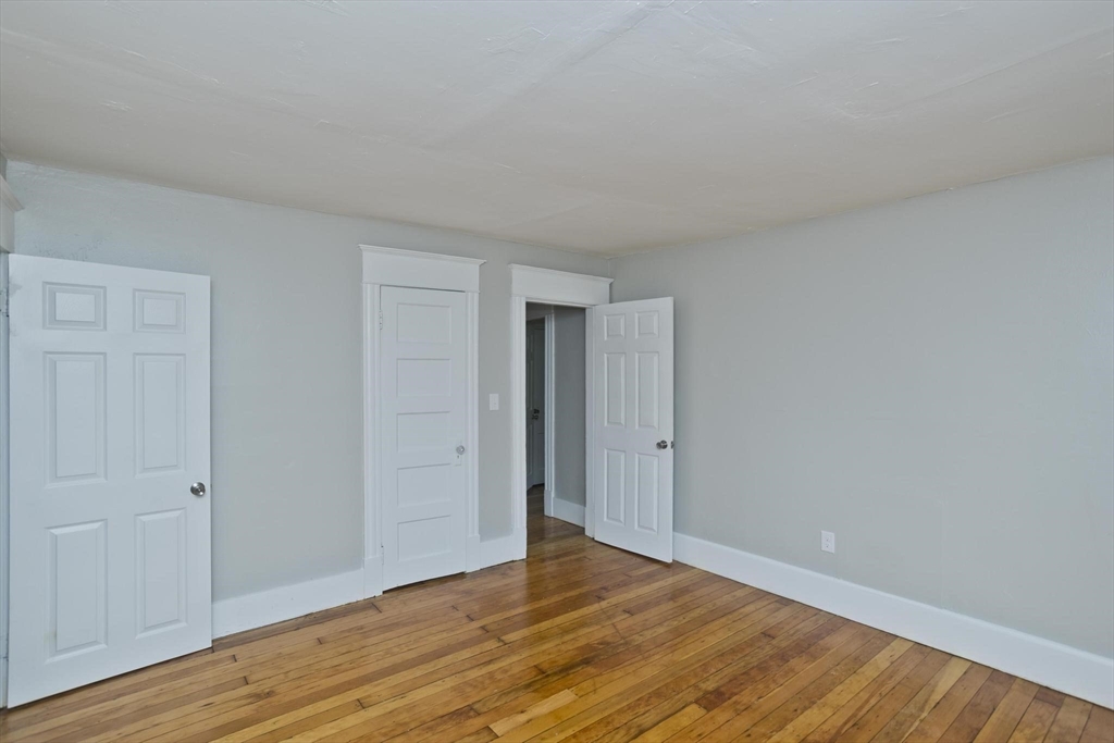 107 Orange Street Springfield, MA 01108 - Photo 29 of 38 a view of an empty room and wooden floor