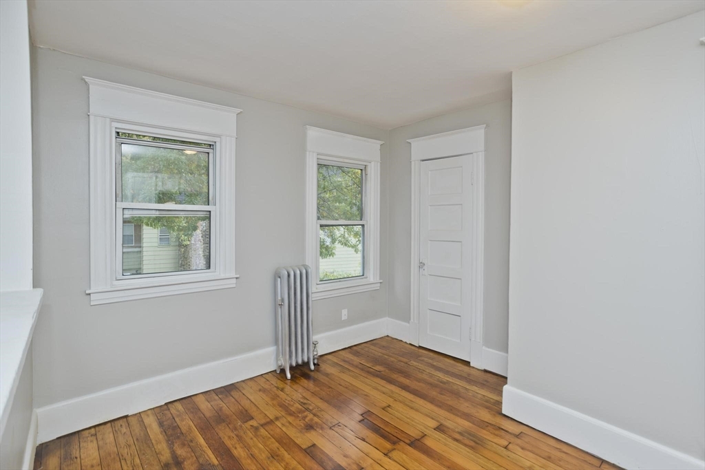 107 Orange Street Springfield, MA 01108 - Photo 32 of 38 an empty room with wooden floor and windows