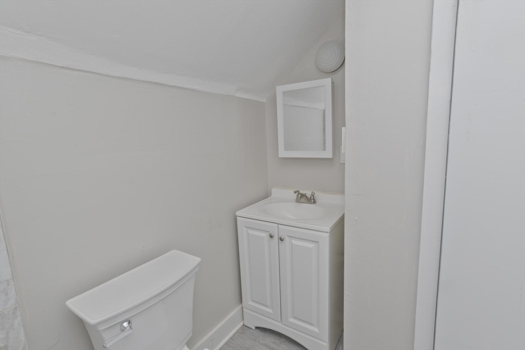107 Orange Street Springfield, MA 01108 - Photo 35 of 38 a bathroom with a toilet sink and vanity