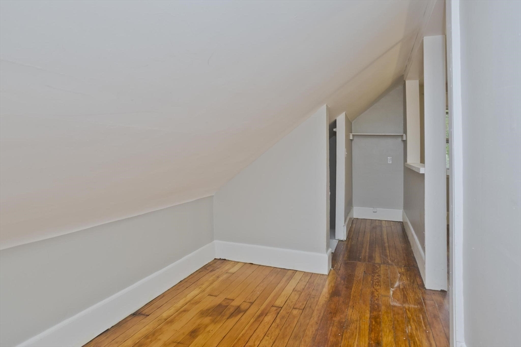 107 Orange Street Springfield, MA 01108 - Photo 37 of 38 a view of a room with wooden floor and brick wall