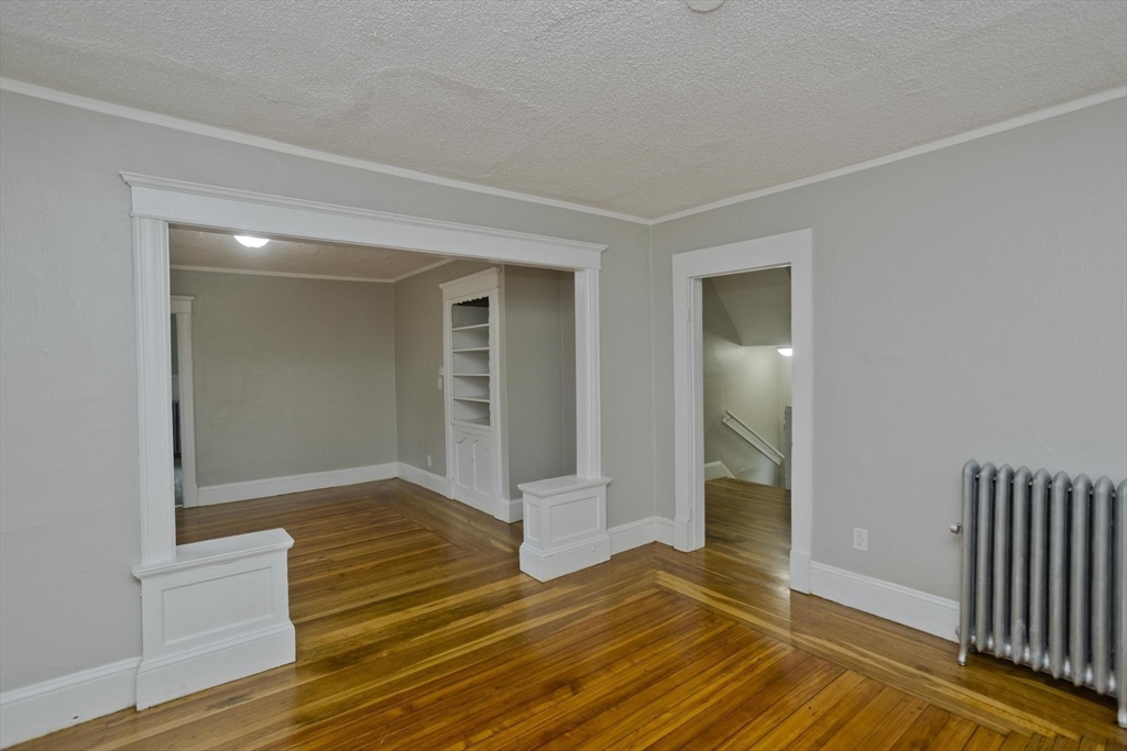 107 Orange Street Springfield, MA 01108 - Photo 6 of 38 a view of an empty room with wooden floor
