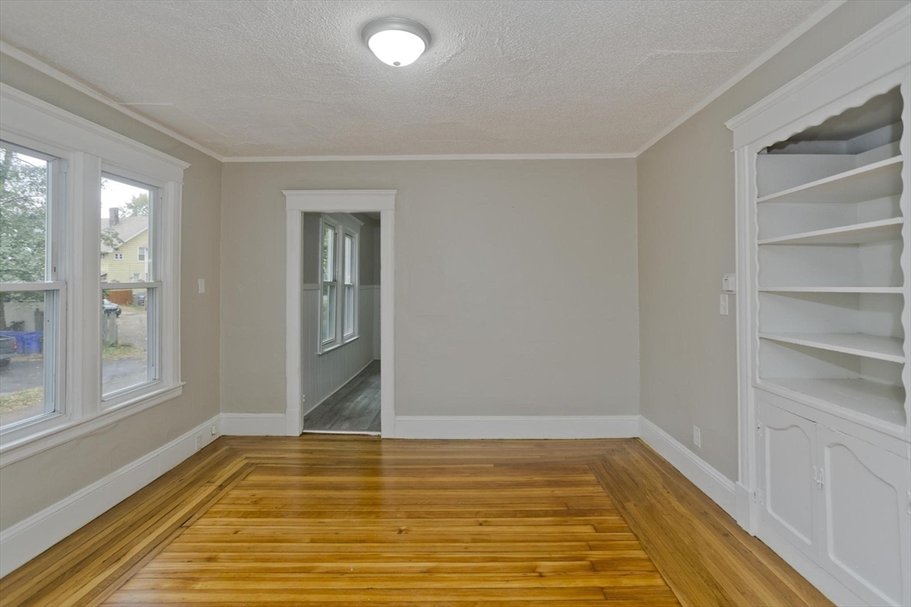 107 Orange Street Springfield, MA 01108 - Photo 8 of 38 a view of empty room with window and wooden floor