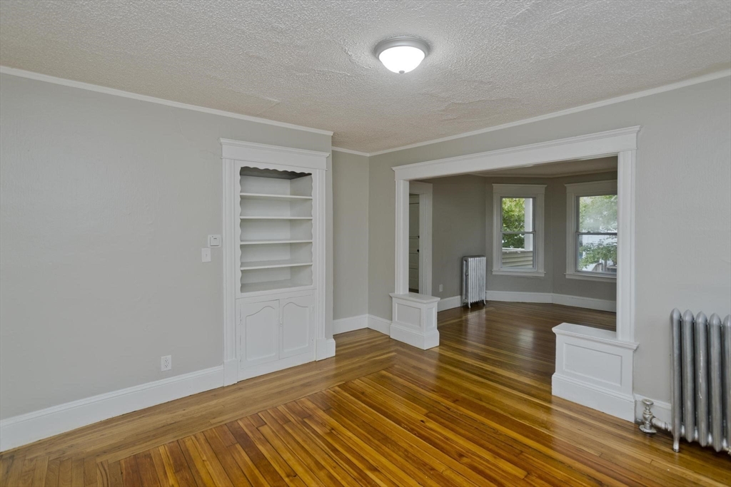 107 Orange Street Springfield, MA 01108 - Photo 9 of 38 a view of empty room with wooden floor