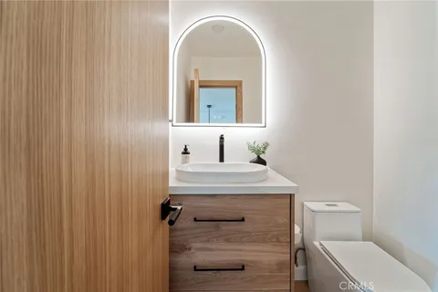 a bathroom with a sink a toilet and shower curtain
