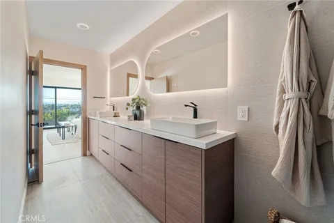 a bathroom with a sink vanity and a mirror