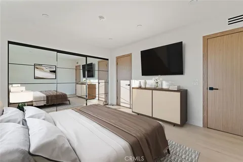 a bedroom with a bed and a flat screen tv