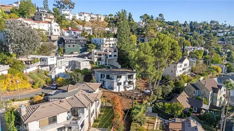 an aerial view of multiple houses with a yard