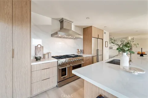 a kitchen with stainless steel appliances a sink stove and refrigerator
