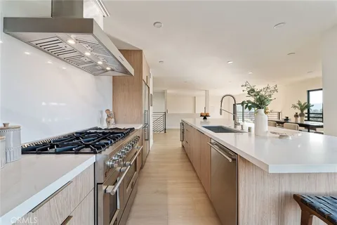 a kitchen with stainless steel appliances a sink dishwasher stove and oven