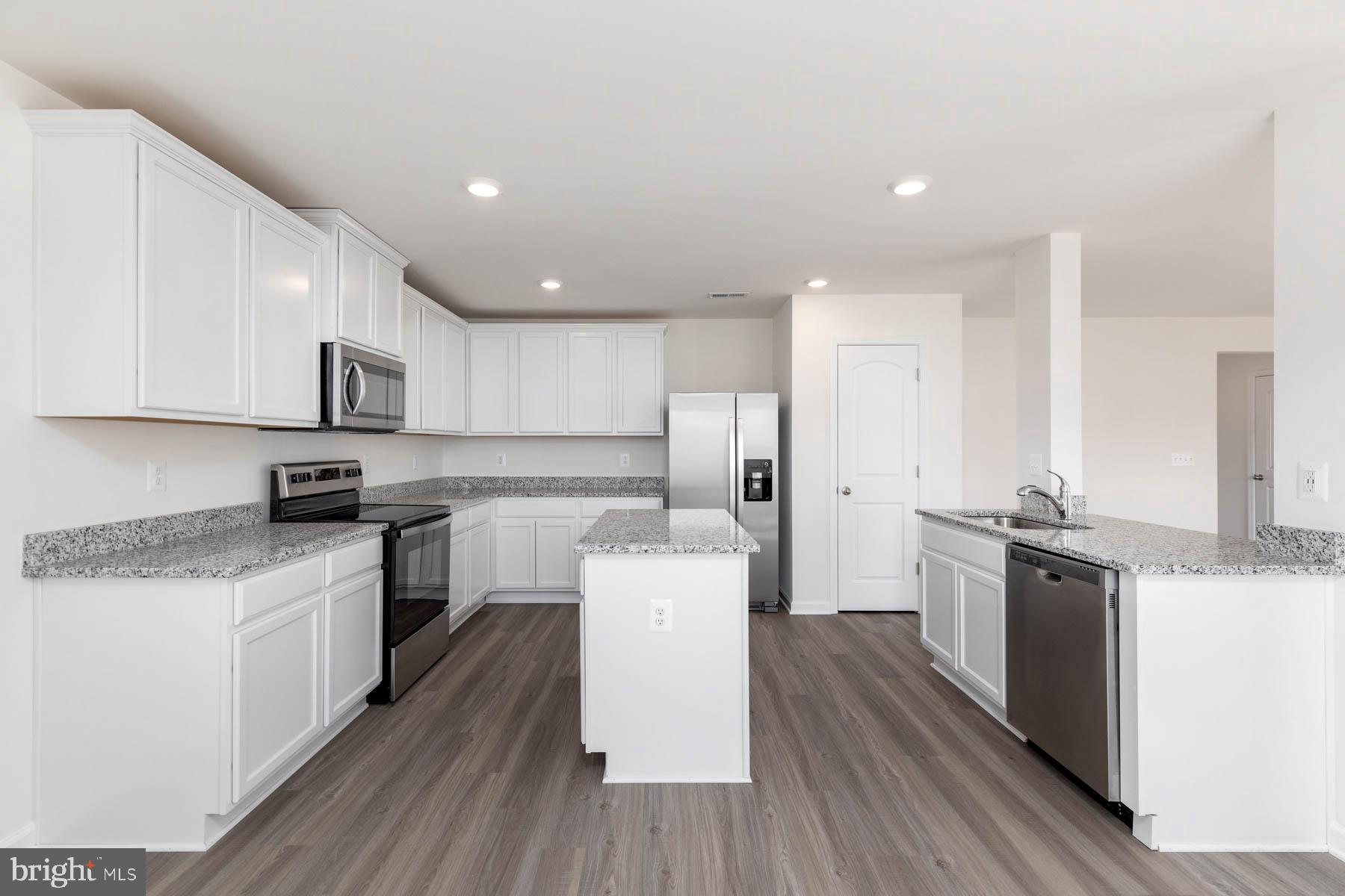 17050 Rollins Road Bowling Green, VA 22427 - Photo 2 of 13 Spacious kitchen with Whirlpool appliances, white