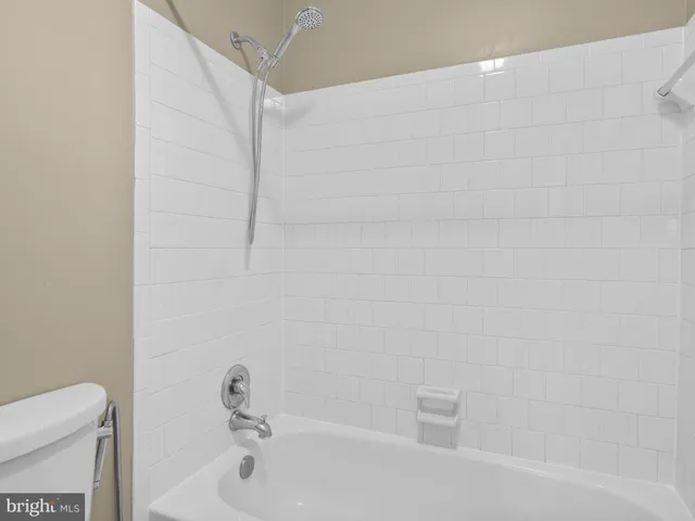 a bathroom with a bathtub and a toilet