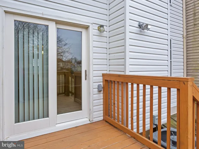 a view of a porch with a table and chairs