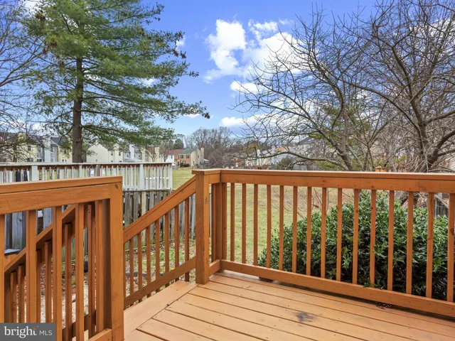 a view of balcony with wooden floor and fence
