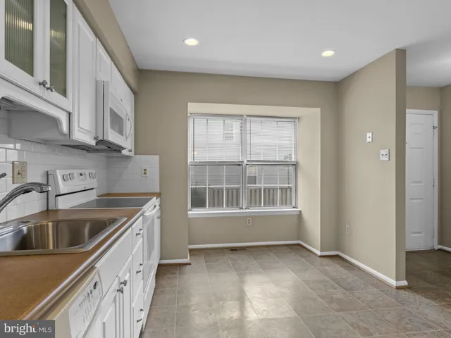 a kitchen that has a sink and a stove