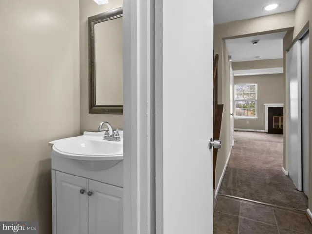 a bathroom with a sink a toilet and mirror