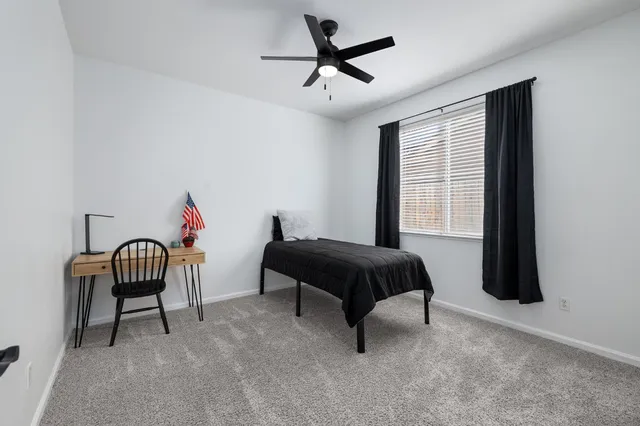 a bedroom with a bed and a chair