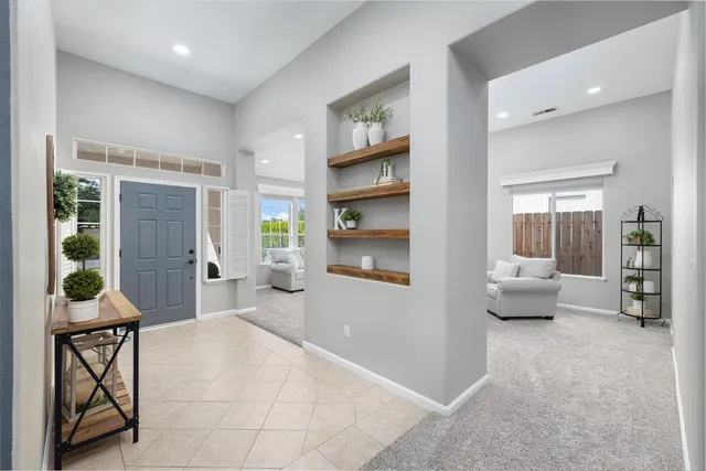 a living room with furniture and a potted plant