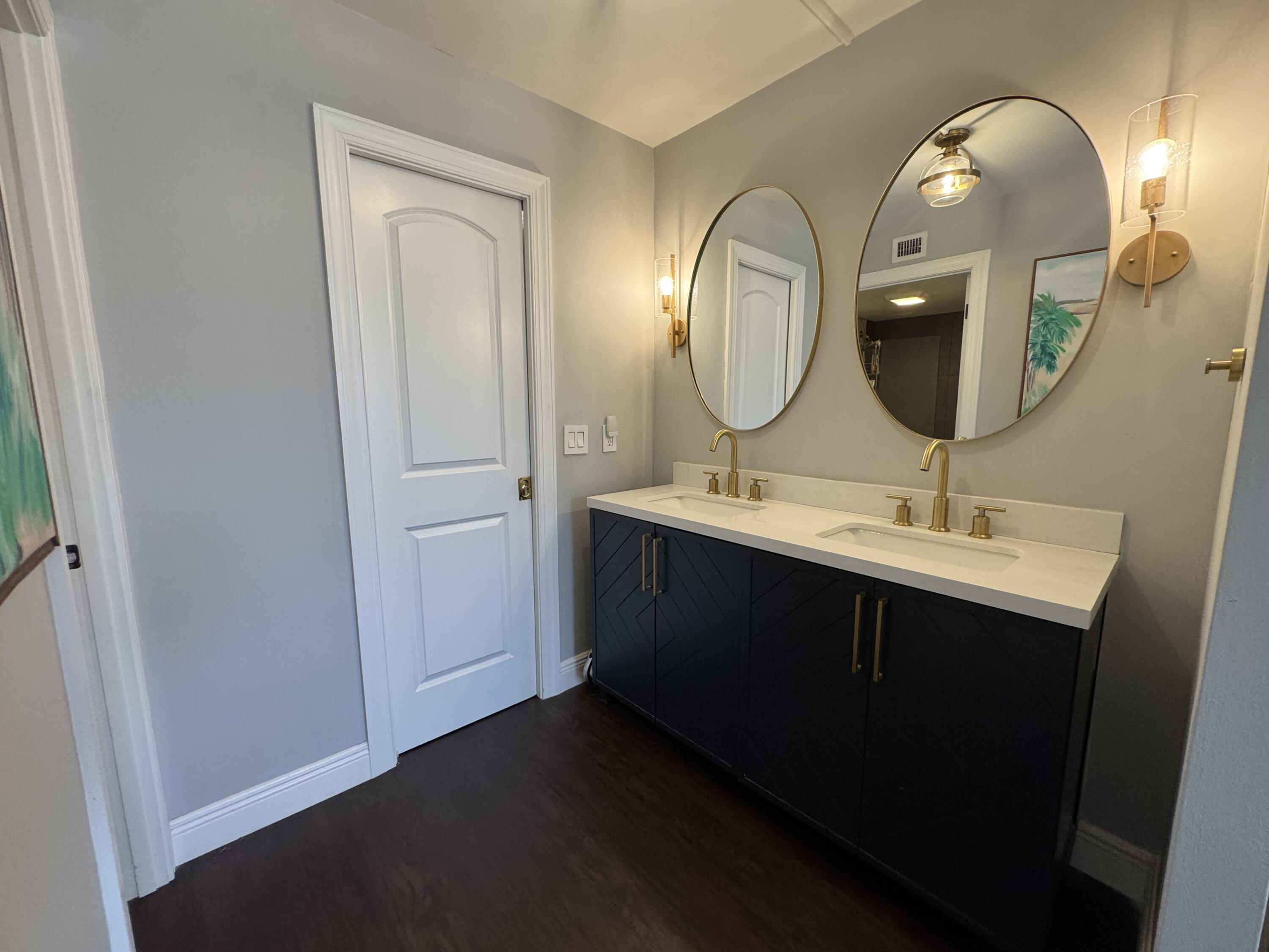 6 Royal Palm Way, Unit 202 Boca Raton, FL 33432 - Photo 8 of 29 a bathroom with a double vanity sink and a mirror