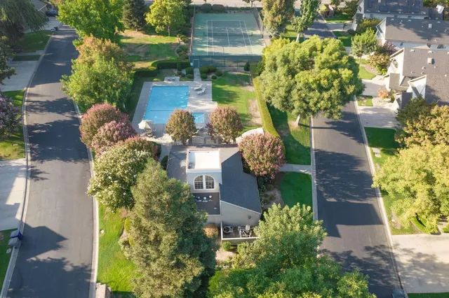 an aerial view of a house with a yard