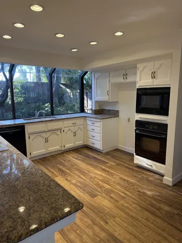a room with wooden floor washer and dryer